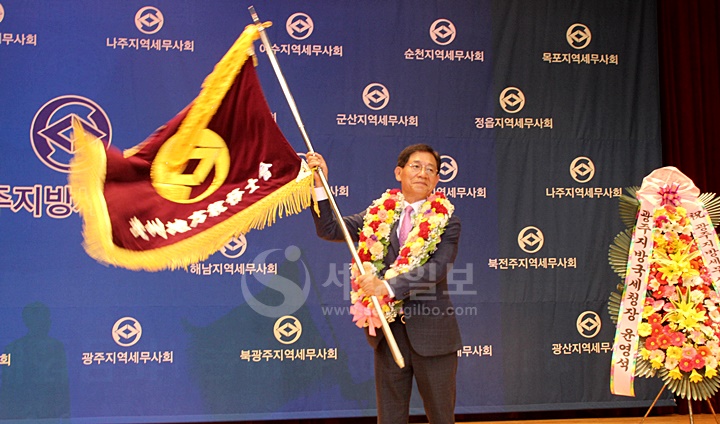 김성후 신임 광주지방세무사회장이 회기를 흔들어 보이고 있다.