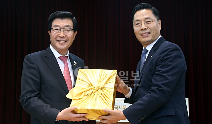 구재이 제33대 한국세무사회장이 직전 원경희 회장에게 기념품을 전달하고 있다.